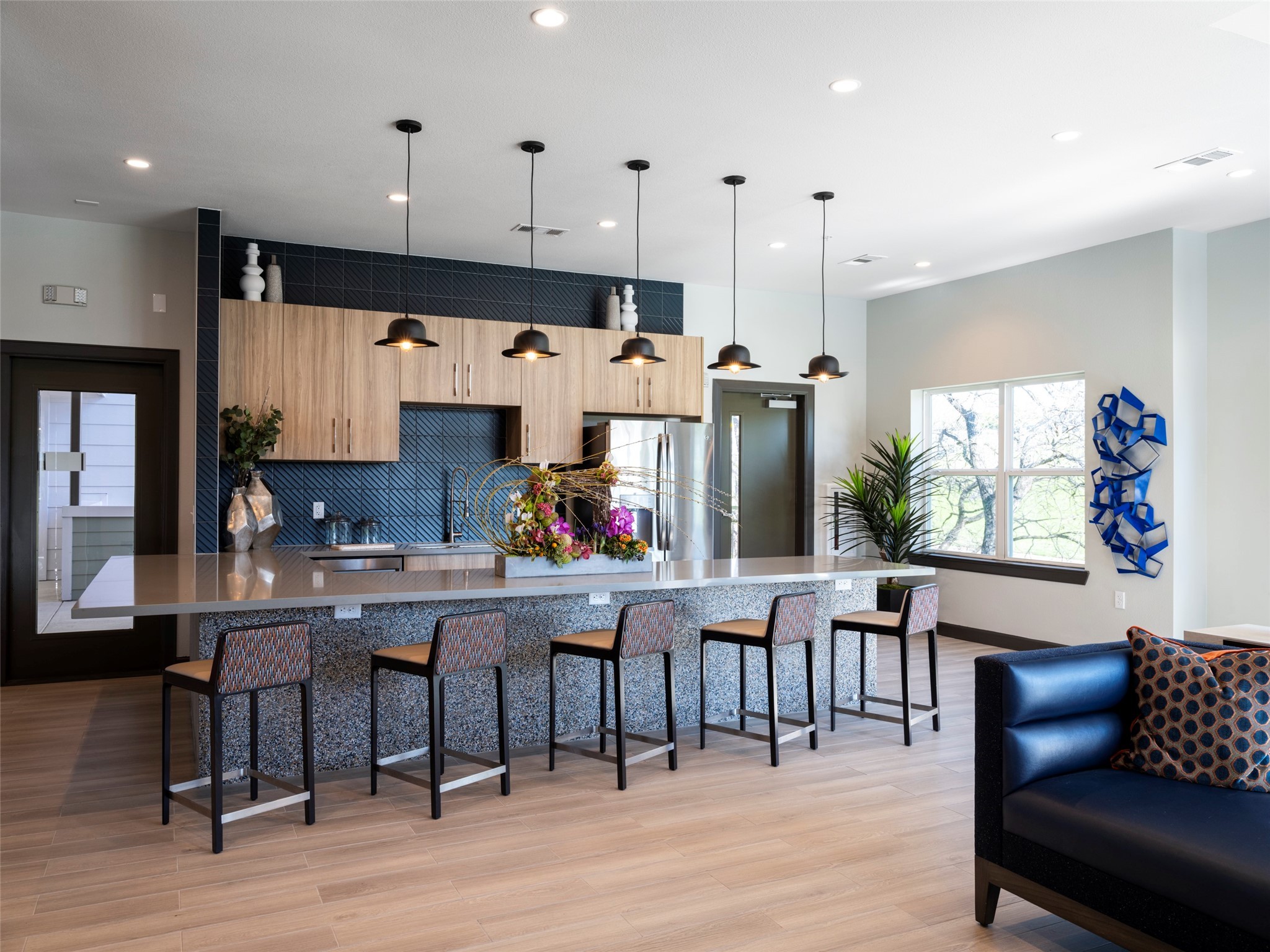 1800 South Interstate 35 Frontage Road Austin, TX 78704 - Photo 25 of 36 a kitchen with stainless steel appliances kitchen island granite countertop a dining table chairs and a refrigerator