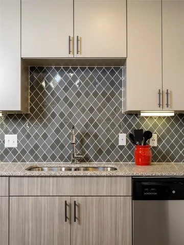 a kitchen with stainless steel appliances granite countertop a stove and a microwave with cabinets
