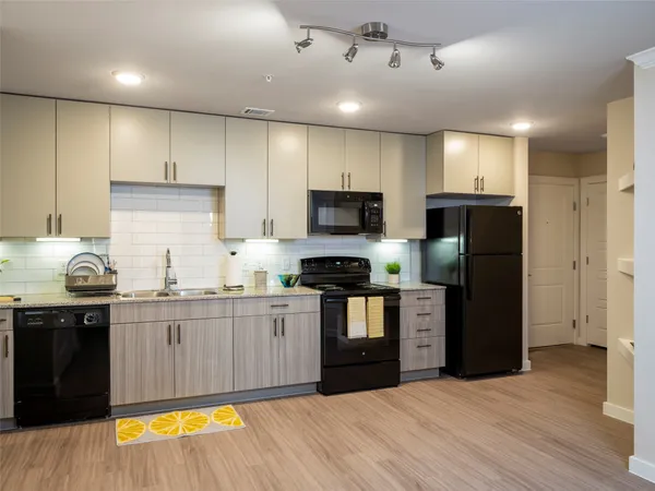 a kitchen with a sink a stove and cabinets