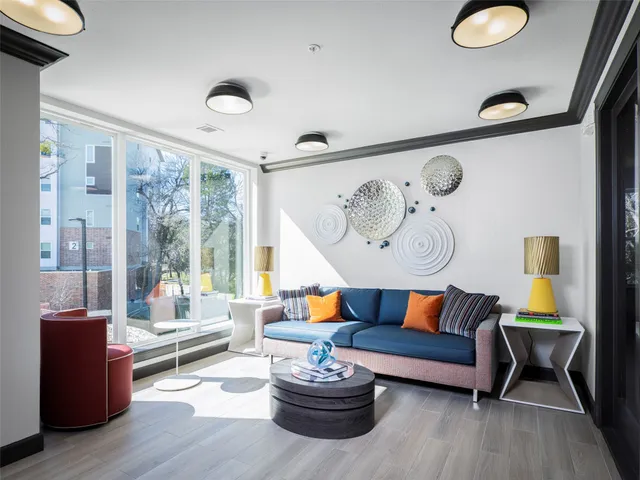 a living room with furniture gym equipment and a large window