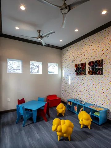a dining room with furniture and a floor to ceiling window