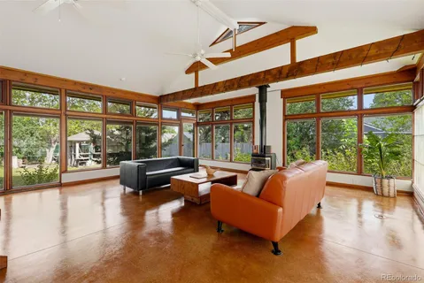 a living room with furniture and floor to ceiling windows