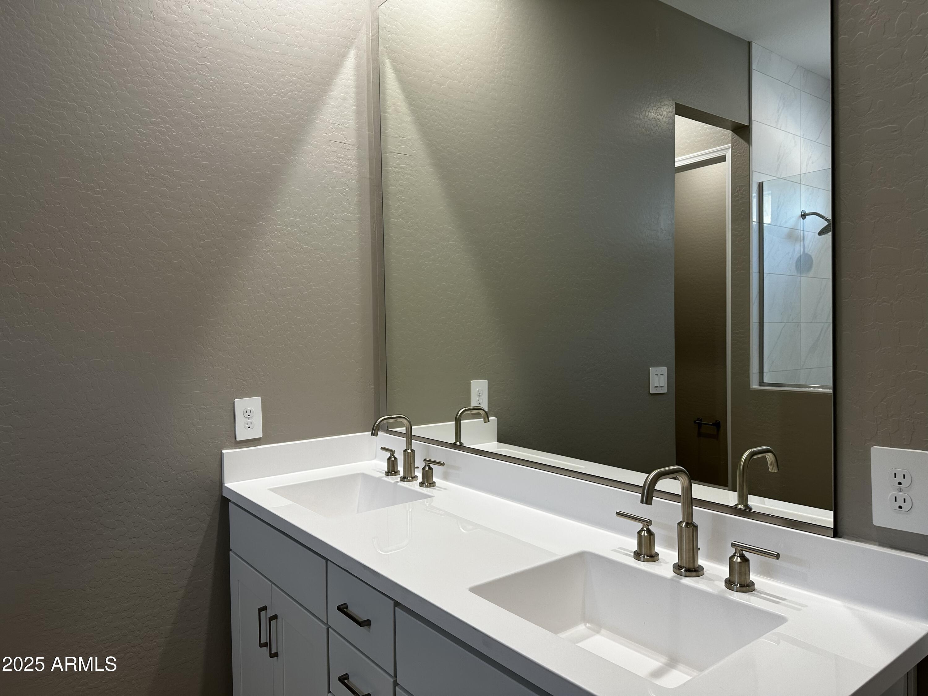 21560 North 102nd Avenue Peoria, AZ 85382 - Photo 11 of 15 a bathroom with a sink and a mirror