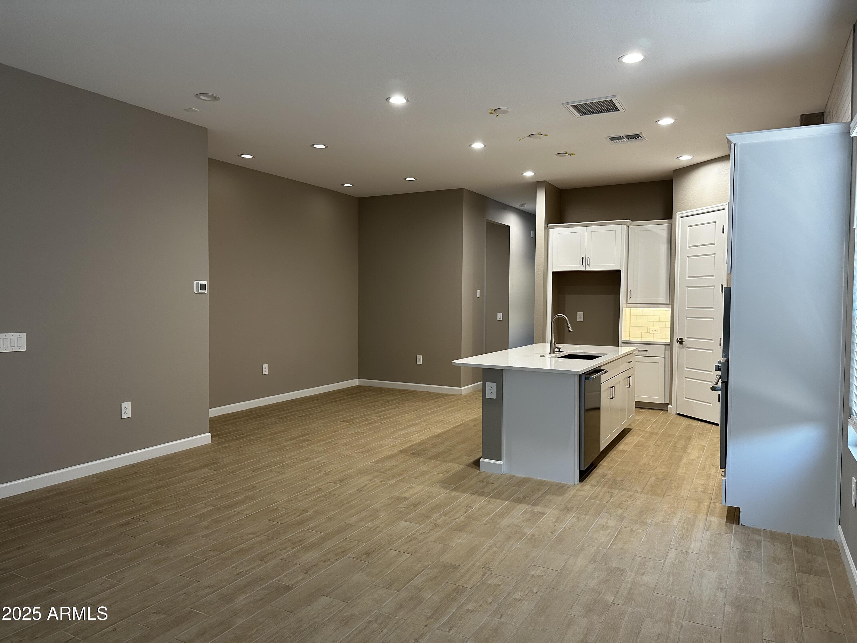 21560 North 102nd Avenue Peoria, AZ 85382 - Photo 6 of 15 a view of a kitchen with kitchen island stainless steel appliances a sink and a stove