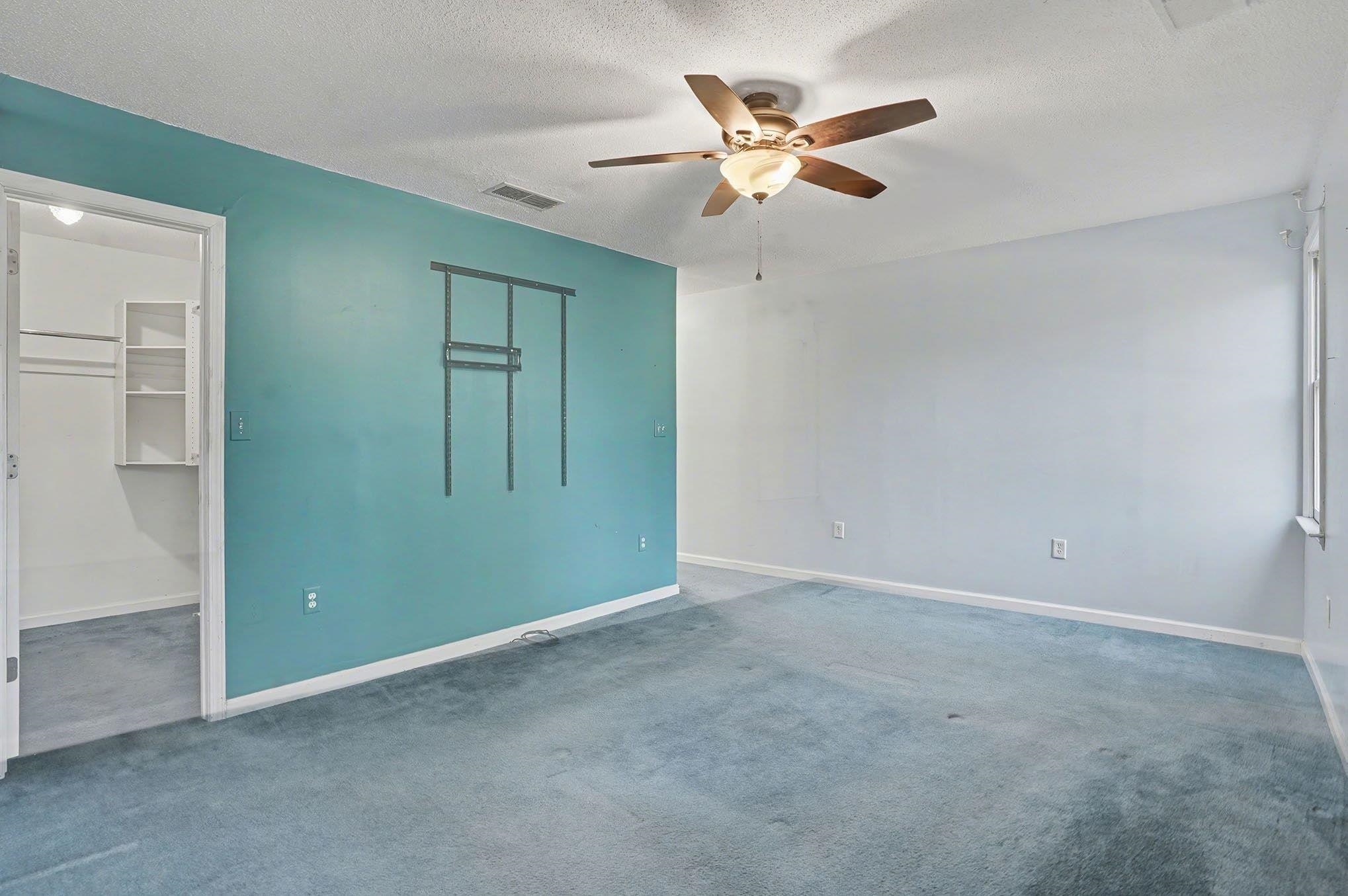 152 Brookgate Drive Myrtle Beach, SC 29579 - Photo 16 of 35 Unfurnished bedroom with carpet floors, a ceiling fan, a textured ceiling, and a walk in closet