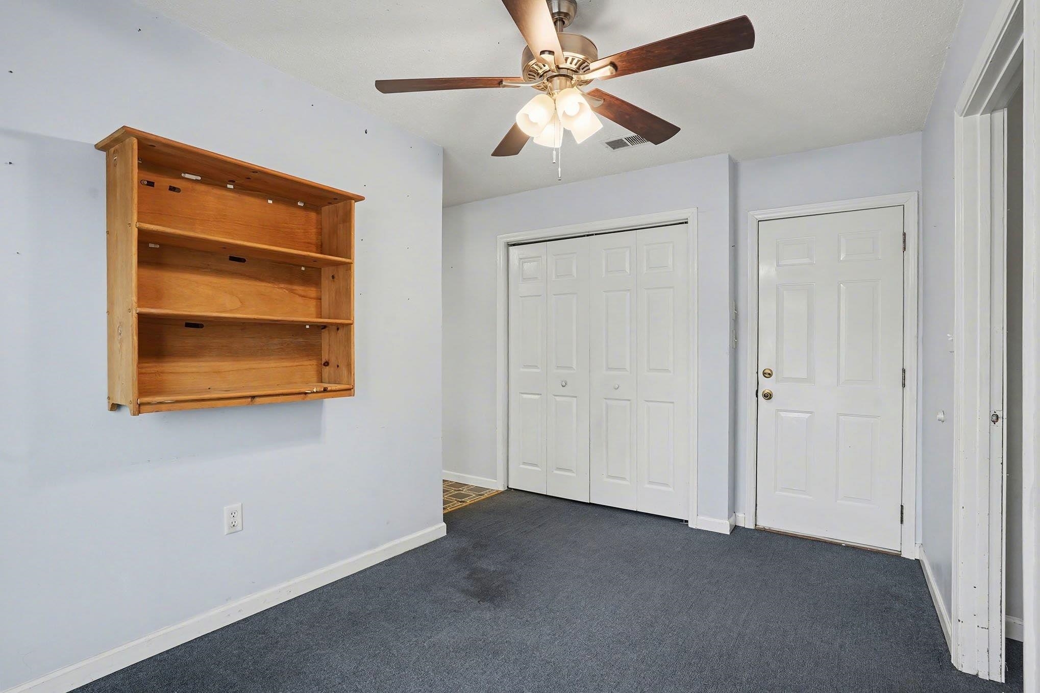 152 Brookgate Drive Myrtle Beach, SC 29579 - Photo 18 of 35 Unfurnished bedroom with ceiling fan, dark carpet, and a closet