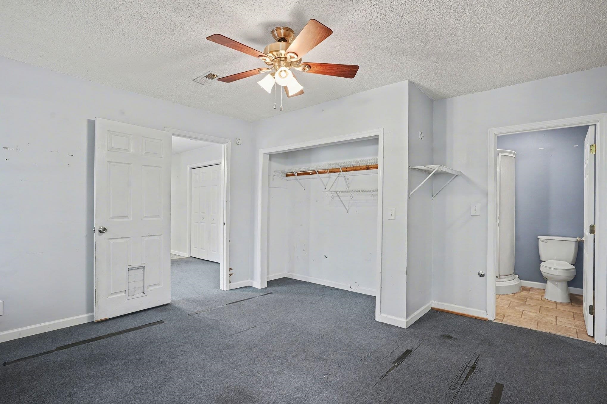 152 Brookgate Drive Myrtle Beach, SC 29579 - Photo 20 of 35 Unfurnished bedroom with a textured ceiling, carpet floors, ceiling fan, and a closet