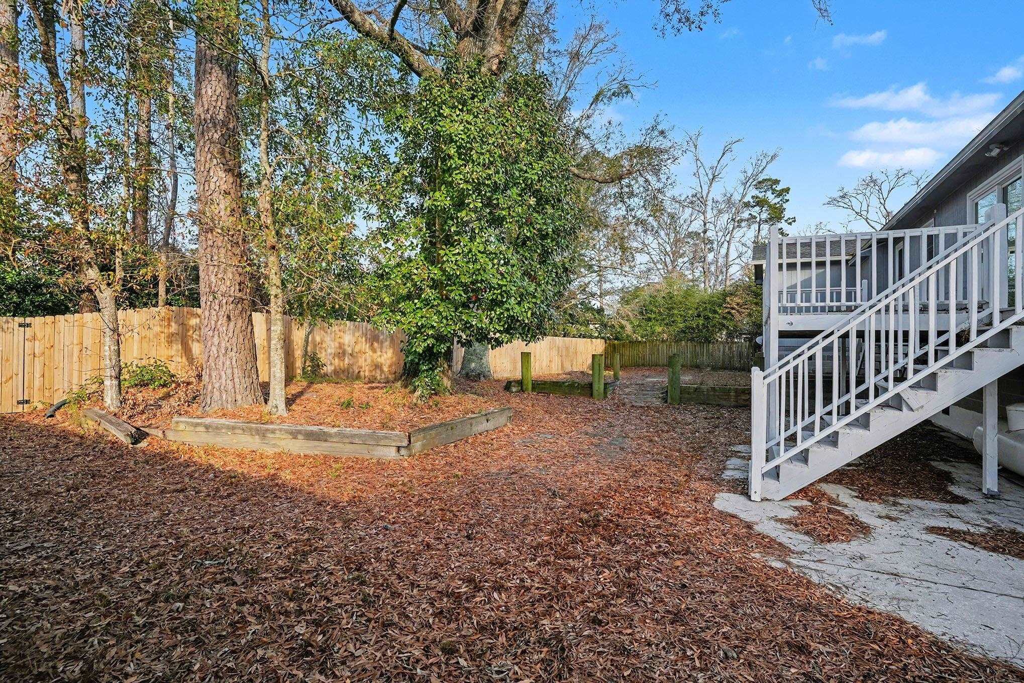 152 Brookgate Drive Myrtle Beach, SC 29579 - Photo 31 of 35 Fenced backyard with stairs, a deck, and a garden