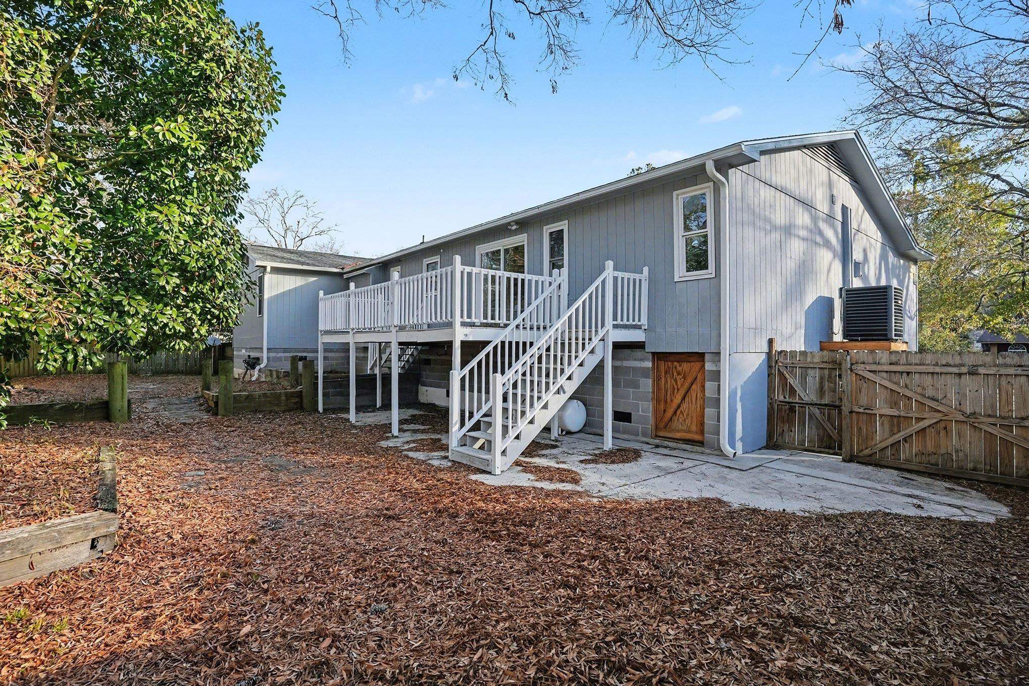 152 Brookgate Drive Myrtle Beach, SC 29579 - Photo 32 of 35 Rear view of house with stairs, a patio area, a gate, and a wooden deck