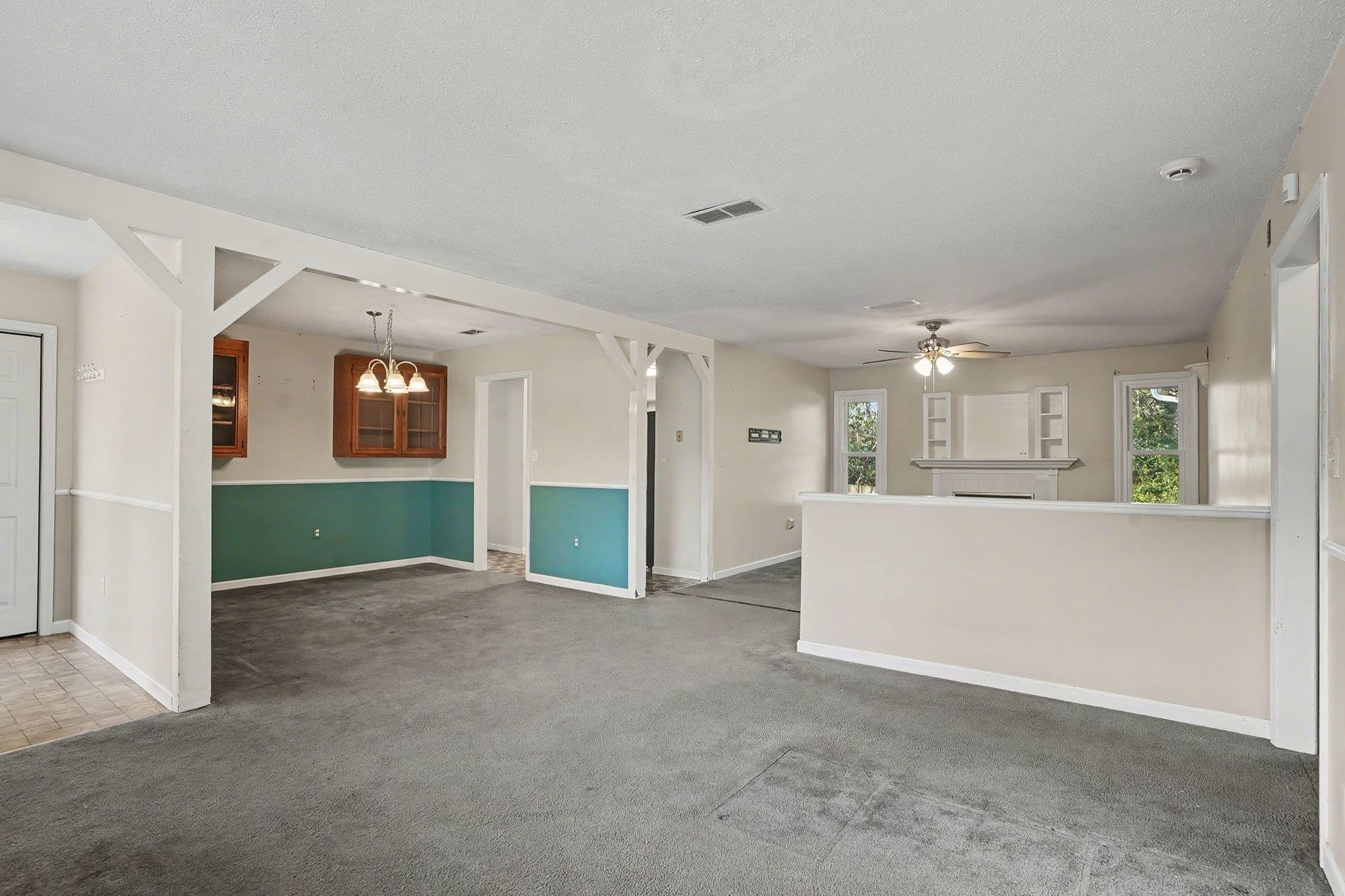 152 Brookgate Drive Myrtle Beach, SC 29579 - Photo 7 of 35 Unfurnished living room with carpet flooring, a ceiling fan, and a textured ceiling