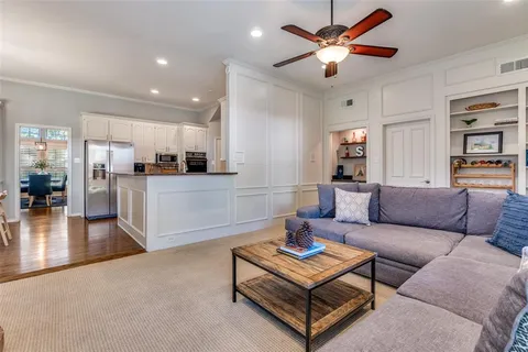 a living room with furniture and kitchen view