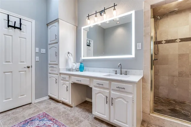 a bathroom with a sink a mirror and a shower