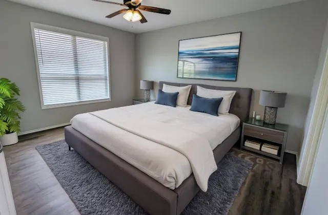 a bedroom with a large bed and a chandelier