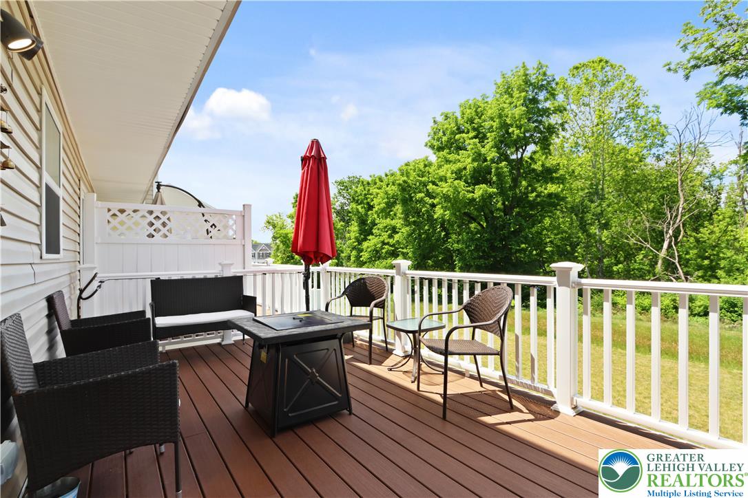 2336 Alex Road Easton, PA 18040 - Photo 25 of 35 An inviting deck extends from the home, offering an ideal setting for relaxation amidst lush greenery.