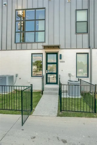 a view of a house with a small yard and plants