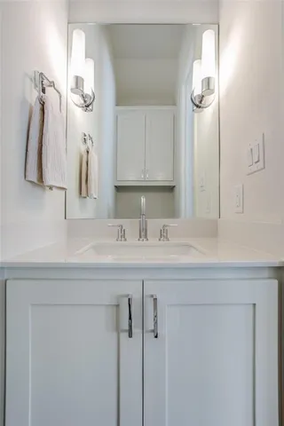 a bathroom with a sink vanity and a mirror