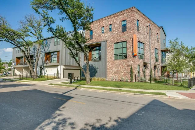 a front view of a building with a garden