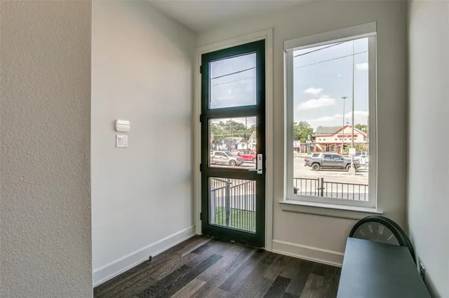 a view of an entryway with wooden floor