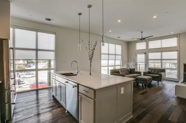 a kitchen with stainless steel appliances granite countertop a stove and wooden floor