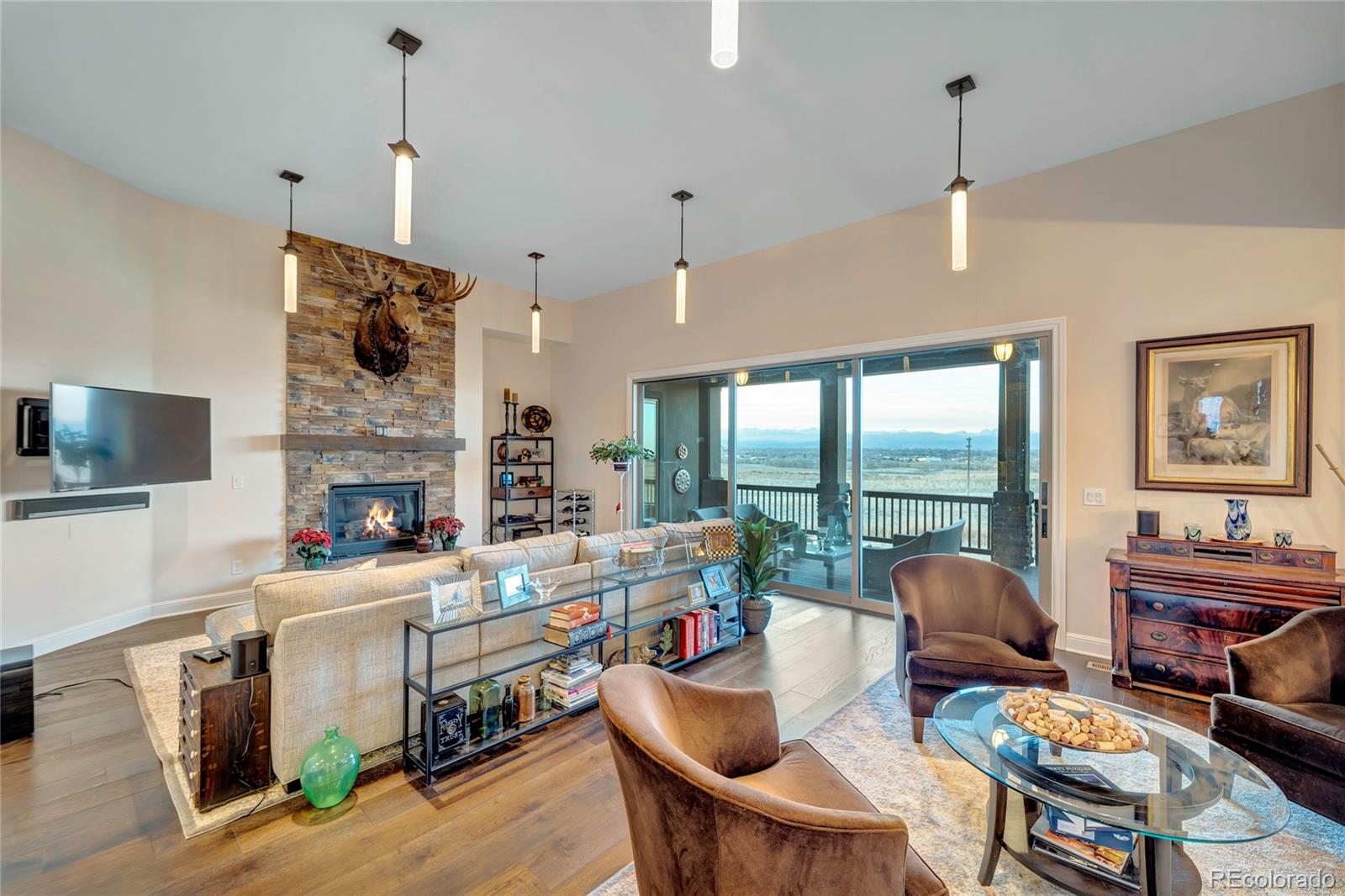 15653 Deer Mountain Circle Broomfield, CO 80023 - Photo 14 of 37 a living room with fireplace furniture and a flat screen tv