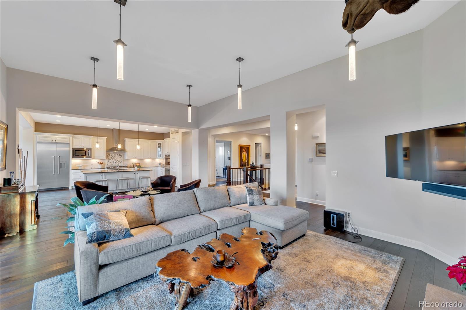 15653 Deer Mountain Circle Broomfield, CO 80023 - Photo 15 of 37 a living room with furniture a rug and kitchen view