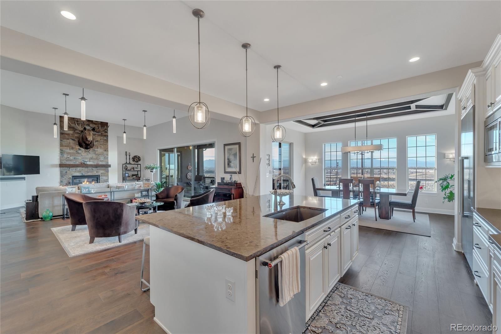 15653 Deer Mountain Circle Broomfield, CO 80023 - Photo 17 of 37 a large kitchen with kitchen island a large island in it