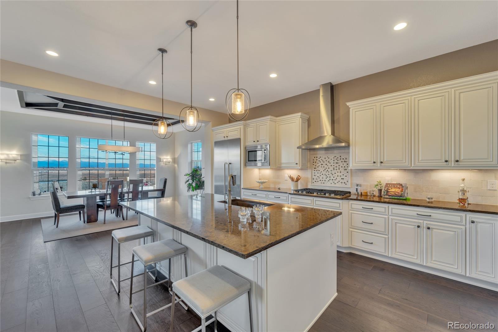 15653 Deer Mountain Circle Broomfield, CO 80023 - Photo 19 of 37 a kitchen with center island table and chairs