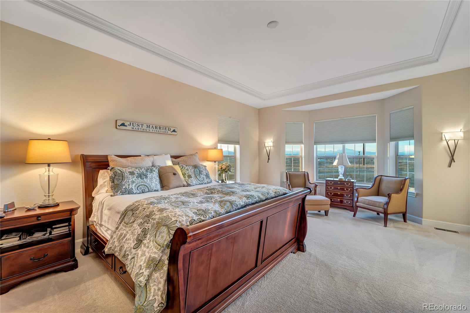 15653 Deer Mountain Circle Broomfield, CO 80023 - Photo 23 of 37 a spacious bedroom with a bed and wooden floor