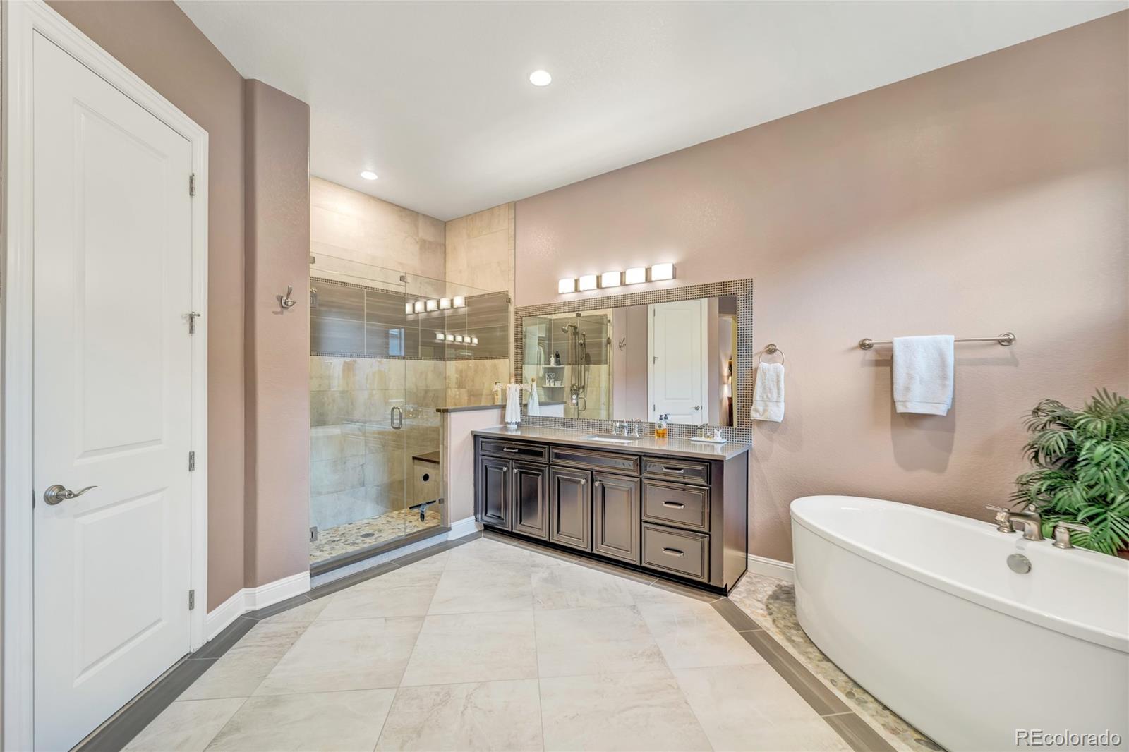 15653 Deer Mountain Circle Broomfield, CO 80023 - Photo 25 of 37 a large bathroom with a granite countertop tub sink and mirror
