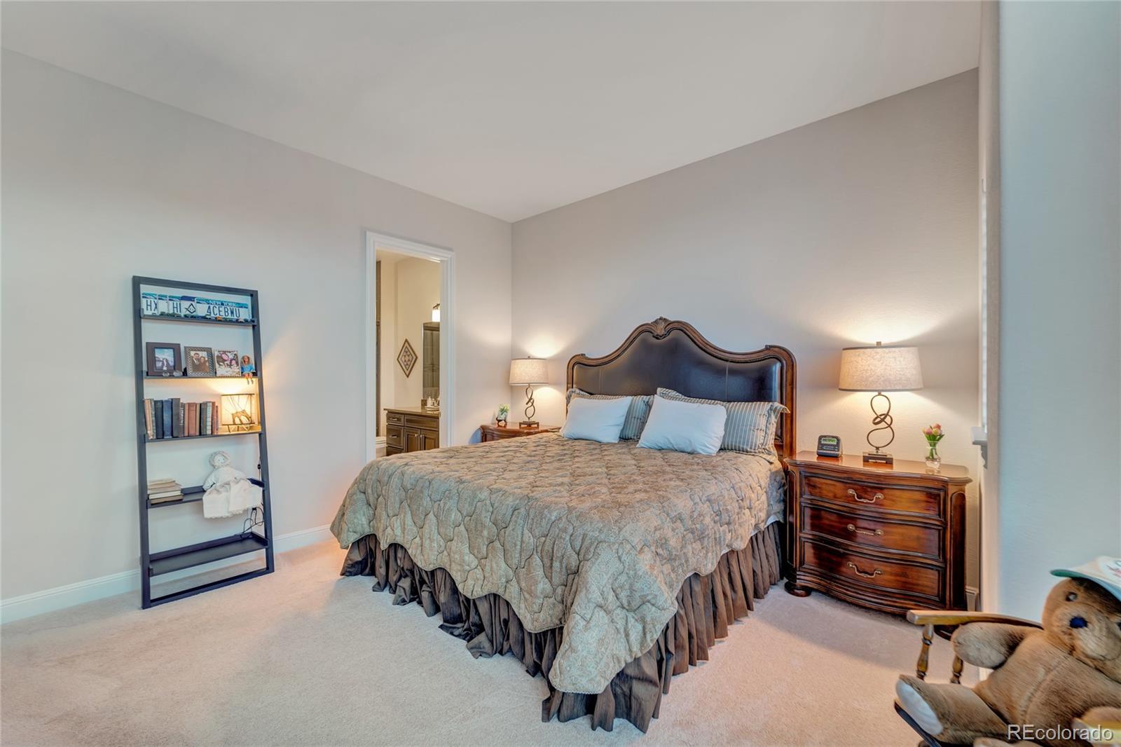 15653 Deer Mountain Circle Broomfield, CO 80023 - Photo 29 of 37 a bedroom with a bed and a night stand
