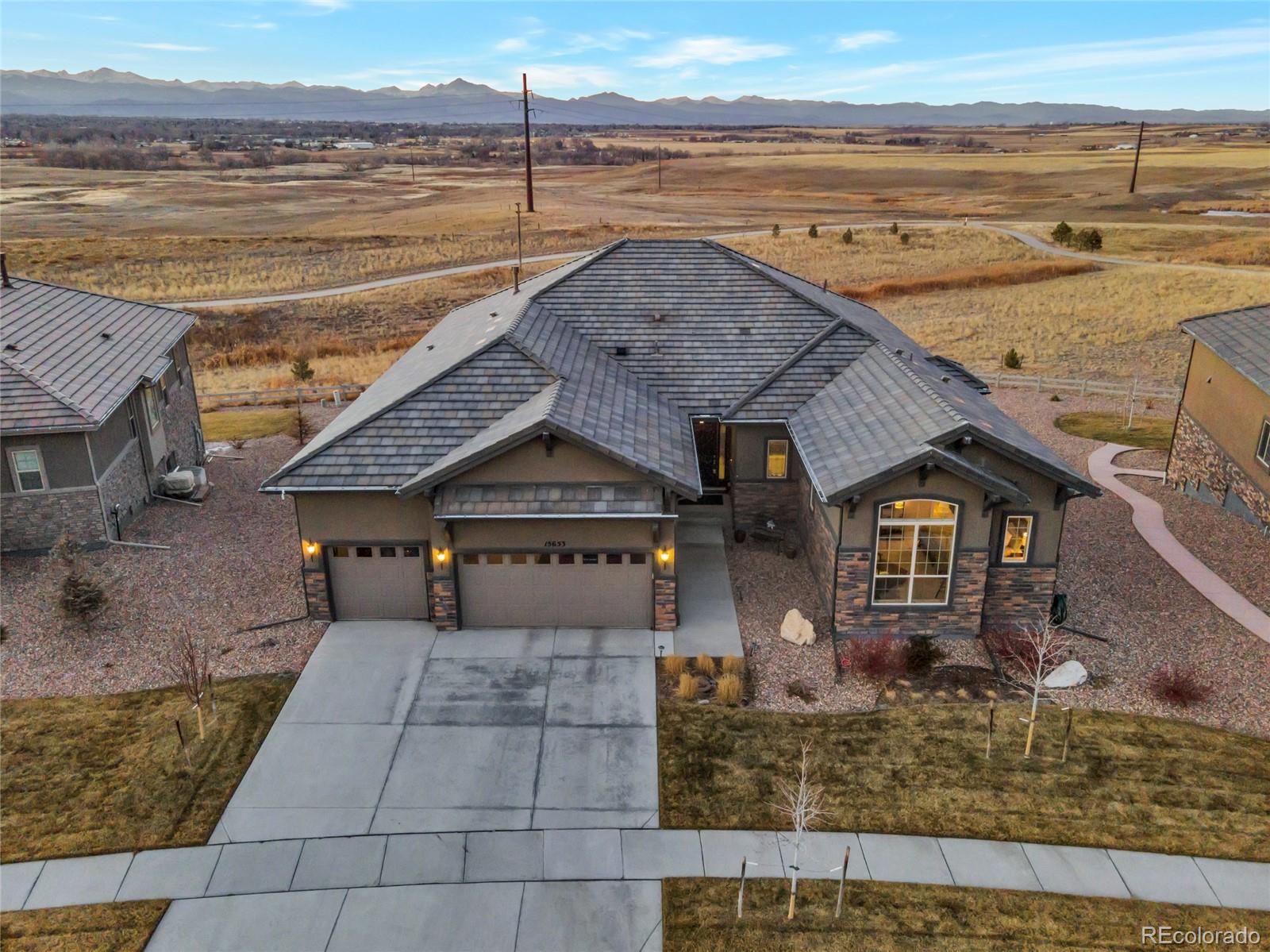 15653 Deer Mountain Circle Broomfield, CO 80023 - Photo 4 of 37 a front view of a house with a yard