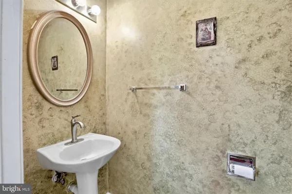 a bathroom with a sink a mirror and a toilet