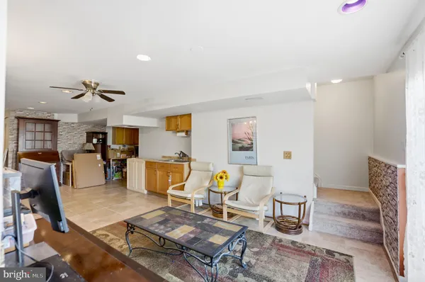 a living room with furniture and kitchen view