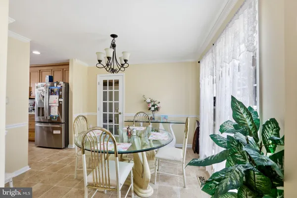 a dining room with furniture and a chandelier