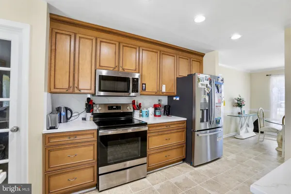 a kitchen with a refrigerator stove and microwave