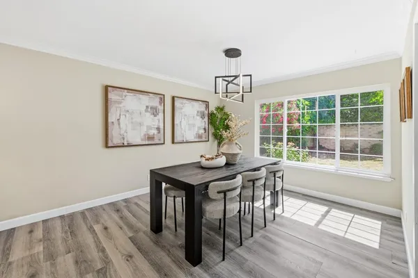 a view of a dining room with furniture and wooden floor