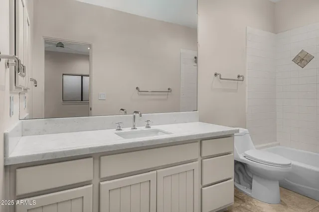 a bathroom with a sink toilet vanity and tub