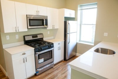 a kitchen with a stove a microwave and refrigerator