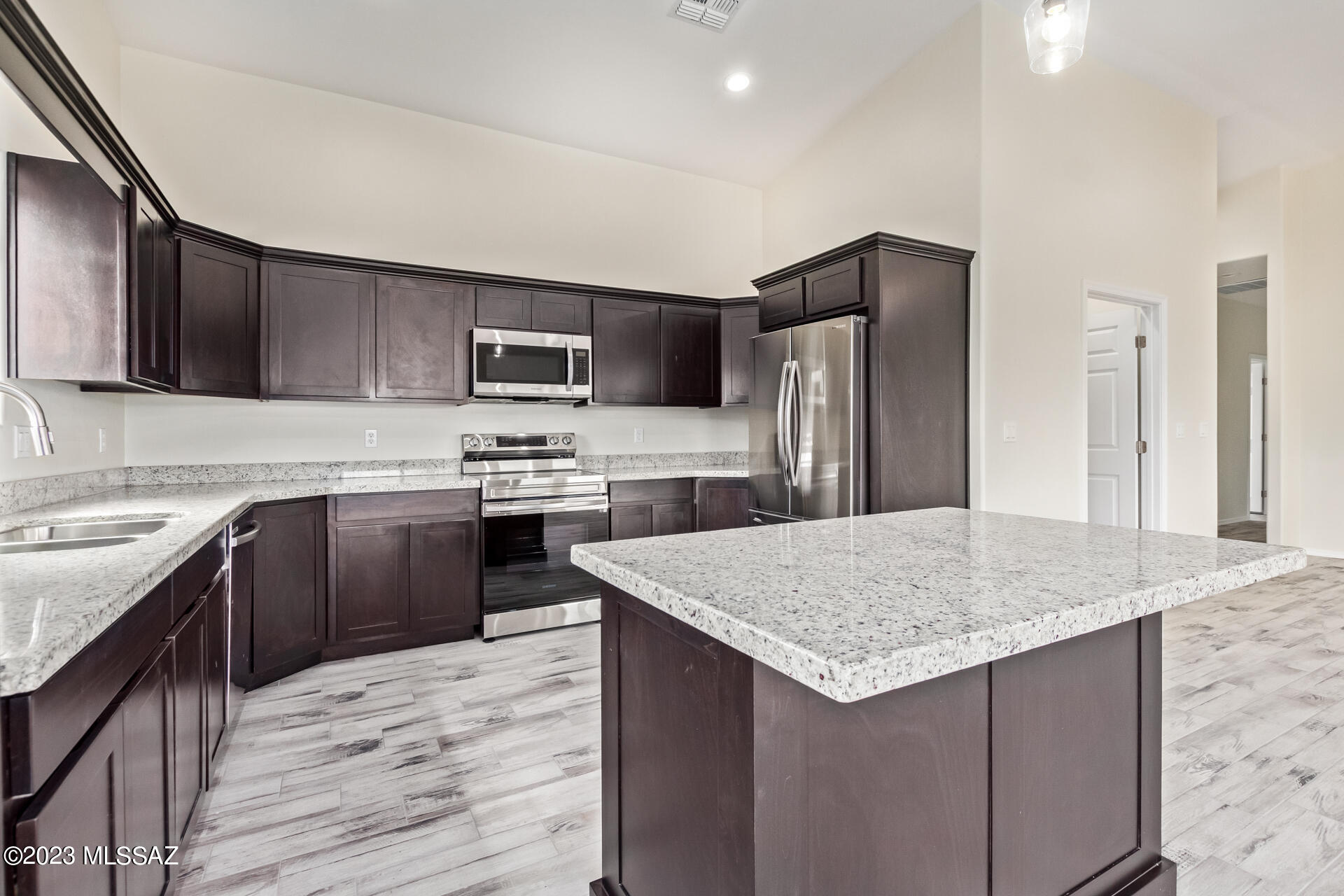 1795 Escobedo Court Rio Rico, AZ 85648 - Photo 11 of 30 a kitchen with a sink a stove a refrigerator and a oven