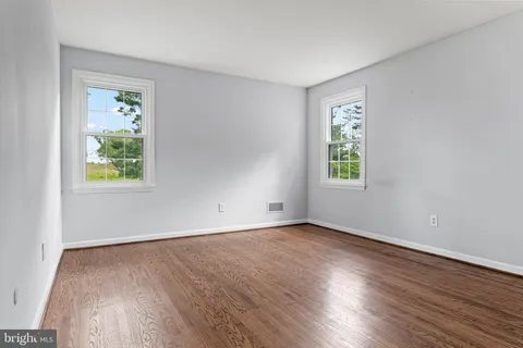 a bathroom with a sink a toilet and a window