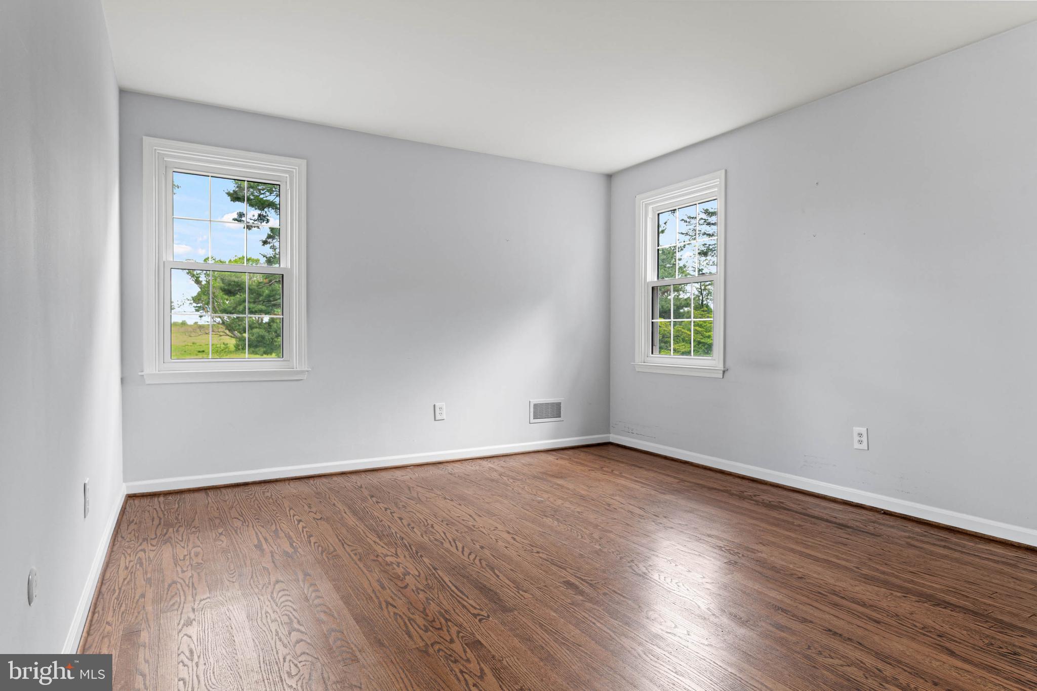 533 Gulph Road Wayne, PA 19087 - Photo 22 of 43 an empty room with a window and wooden floor