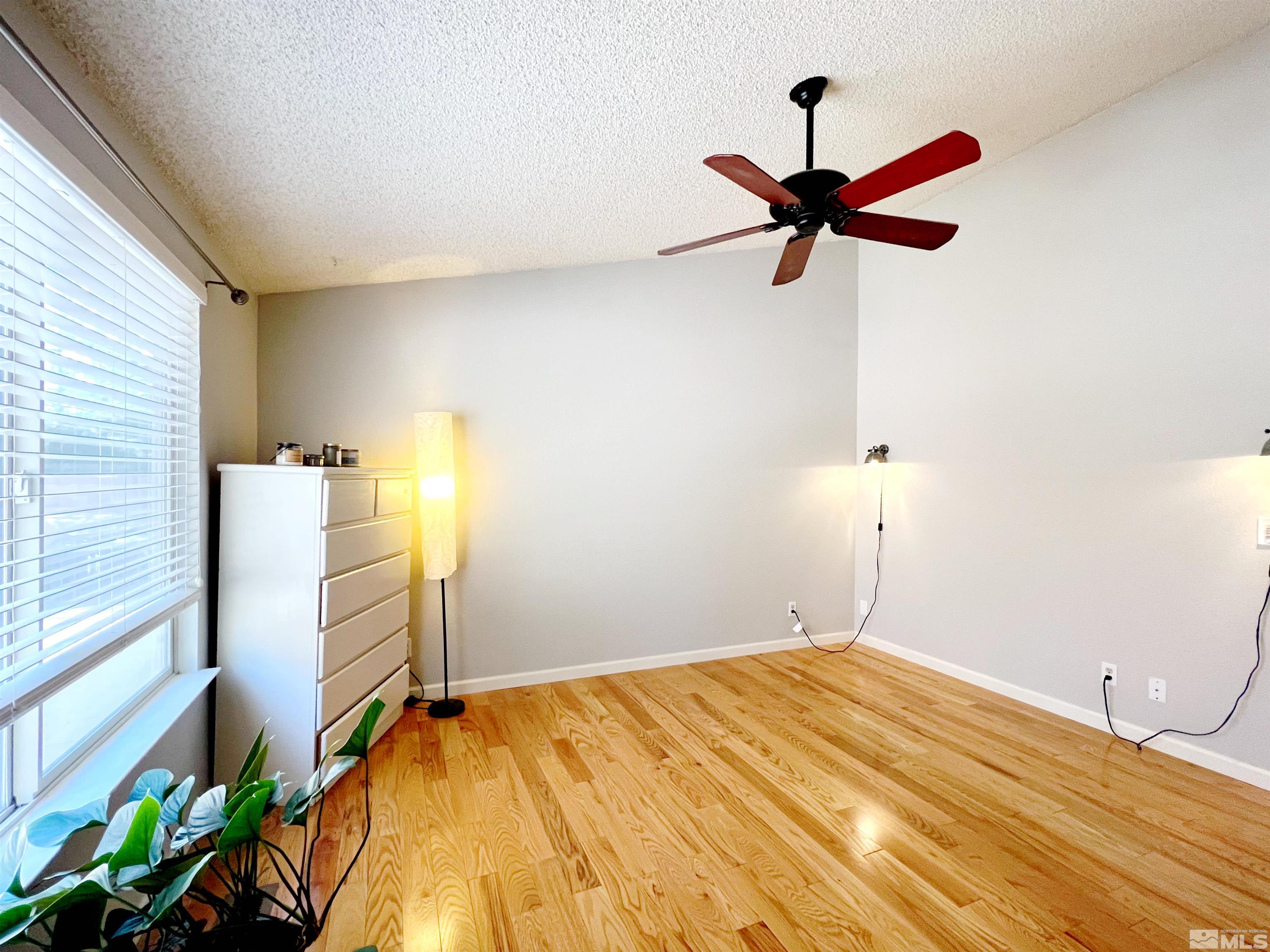 3849 Bexley Square Reno, NV 89503 - Photo 16 of 37 a bedroom with a bed and a chandelier