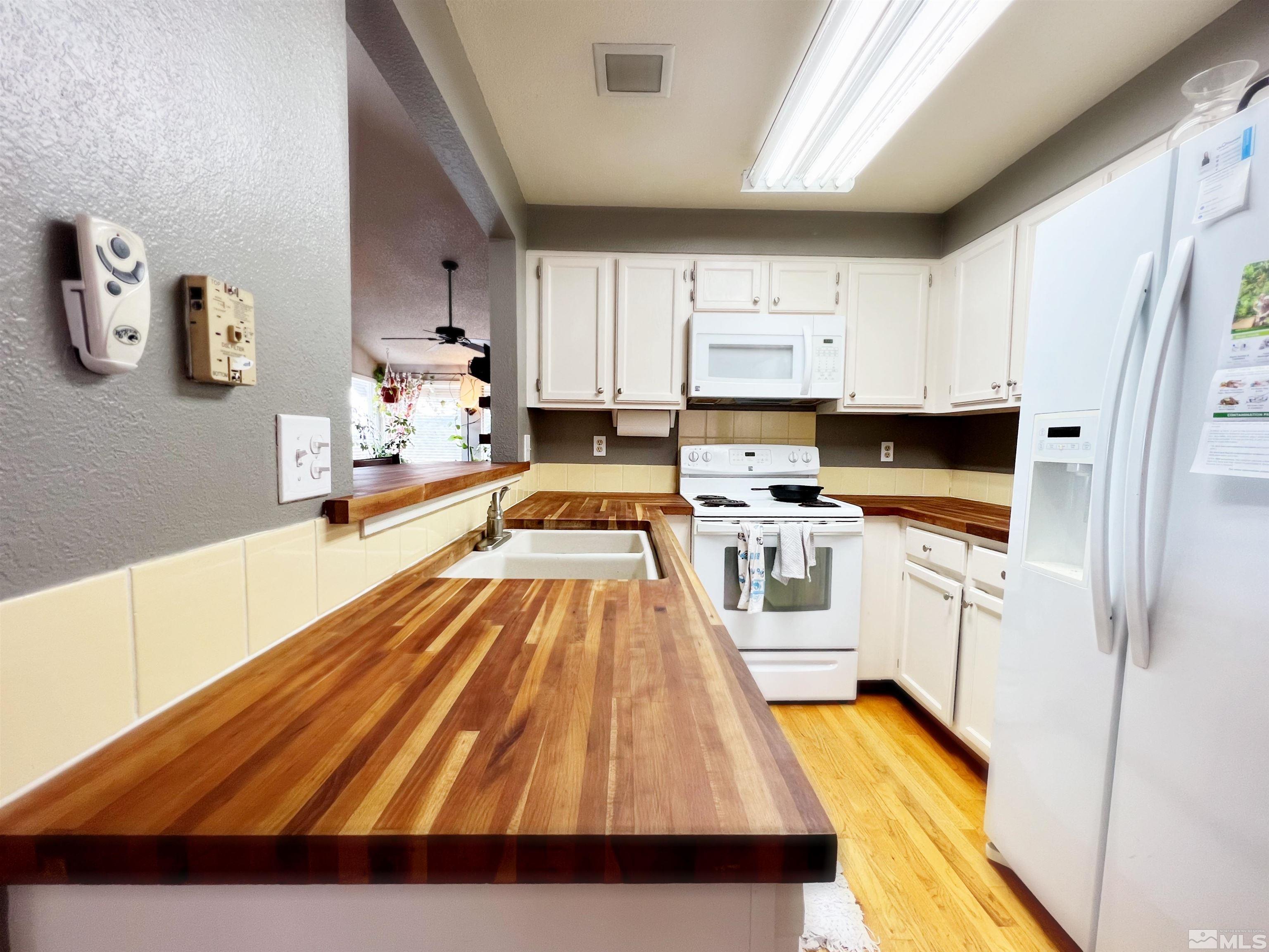 3849 Bexley Square Reno, NV 89503 - Photo 23 of 37 a kitchen with stainless steel appliances cabinets a sink and a stove