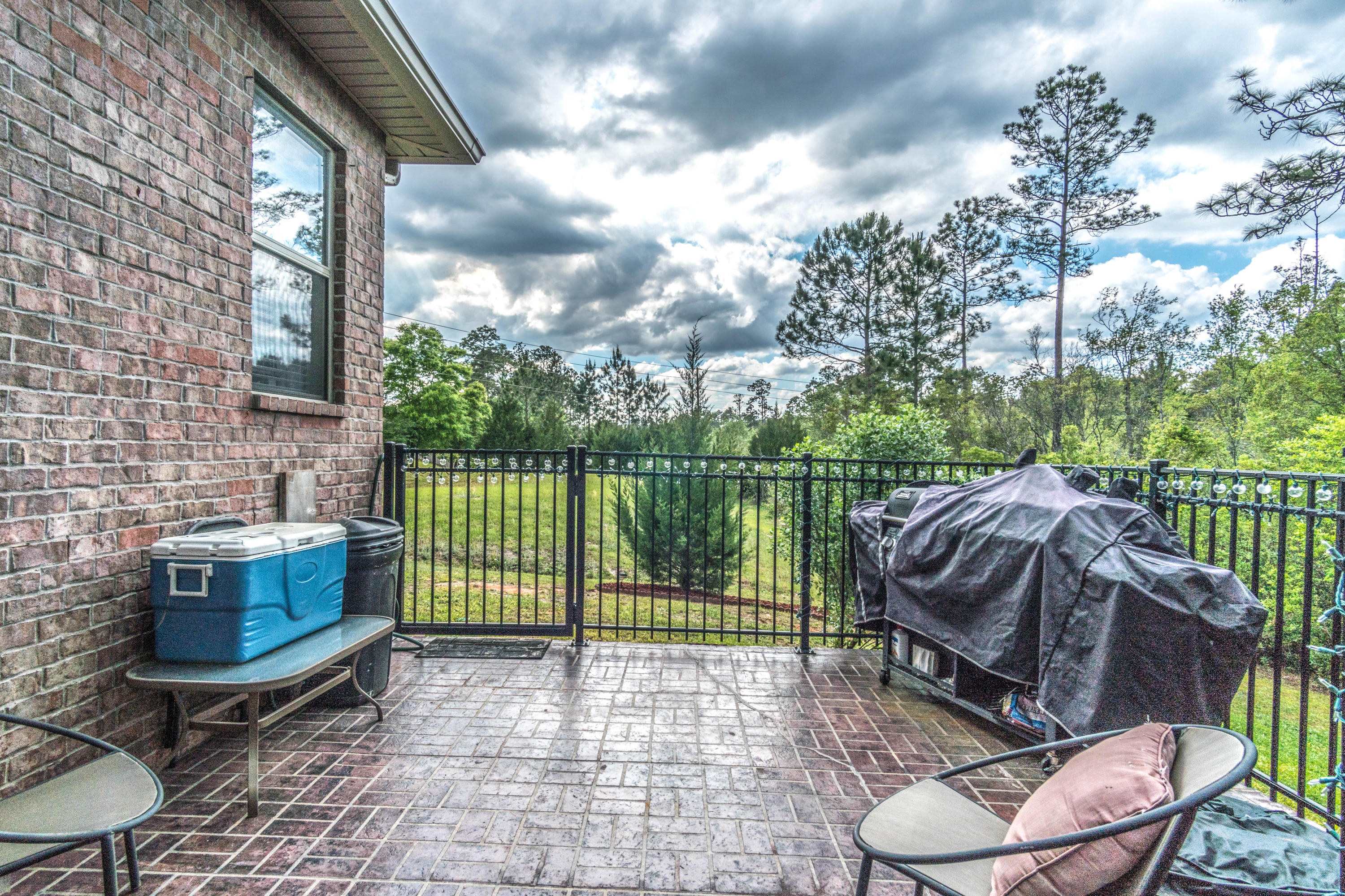 604 Red Fern Road Crestview, FL 32536 - Photo 19 of 36 a view of backyard with barbeque grill and iron fence