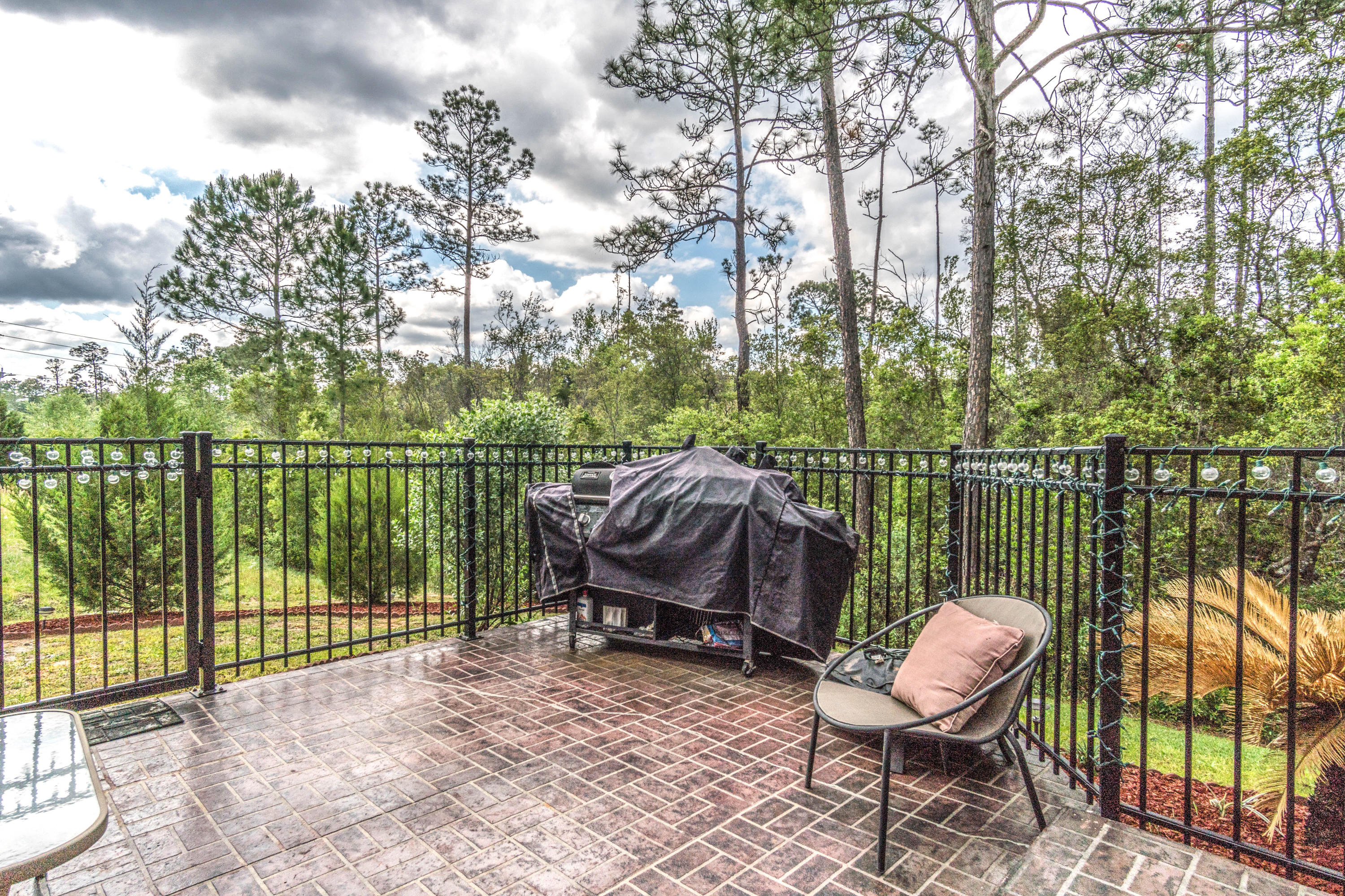 604 Red Fern Road Crestview, FL 32536 - Photo 20 of 36 a view of a roof deck with chair and wooden fence