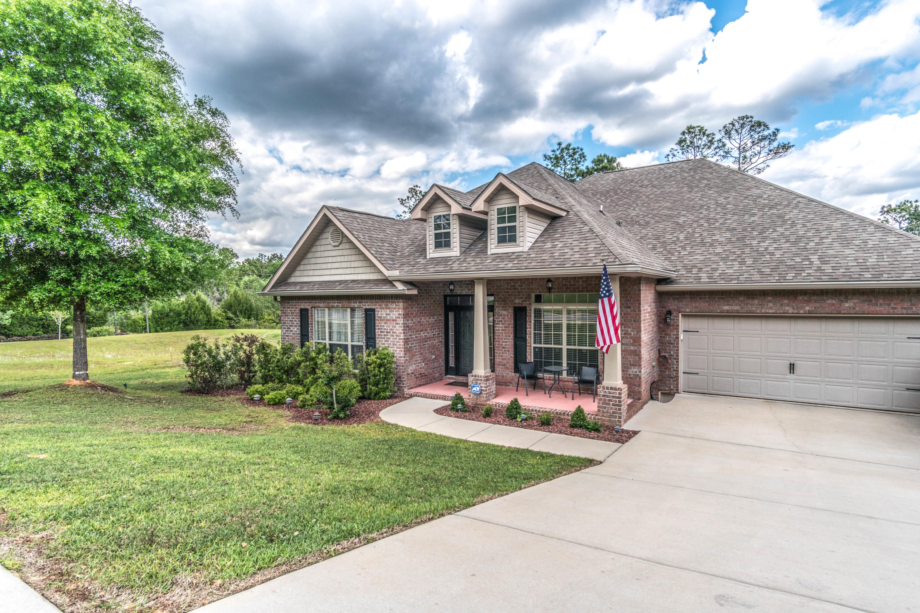 604 Red Fern Road Crestview, FL 32536 - Photo 2 of 36 a front view of a house with a garden and plants