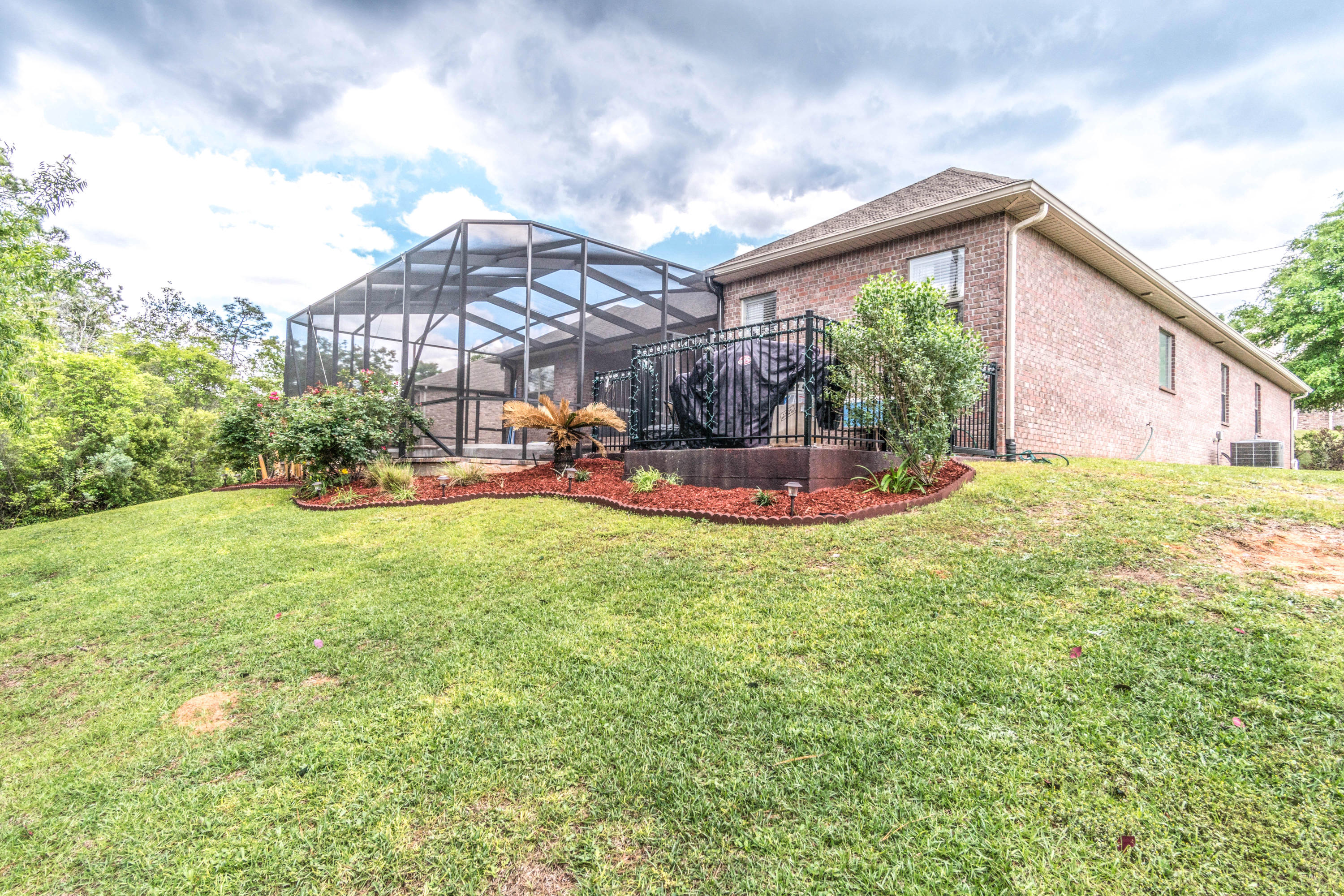 604 Red Fern Road Crestview, FL 32536 - Photo 21 of 36 a backyard of a house with table and chairs under an umbrella