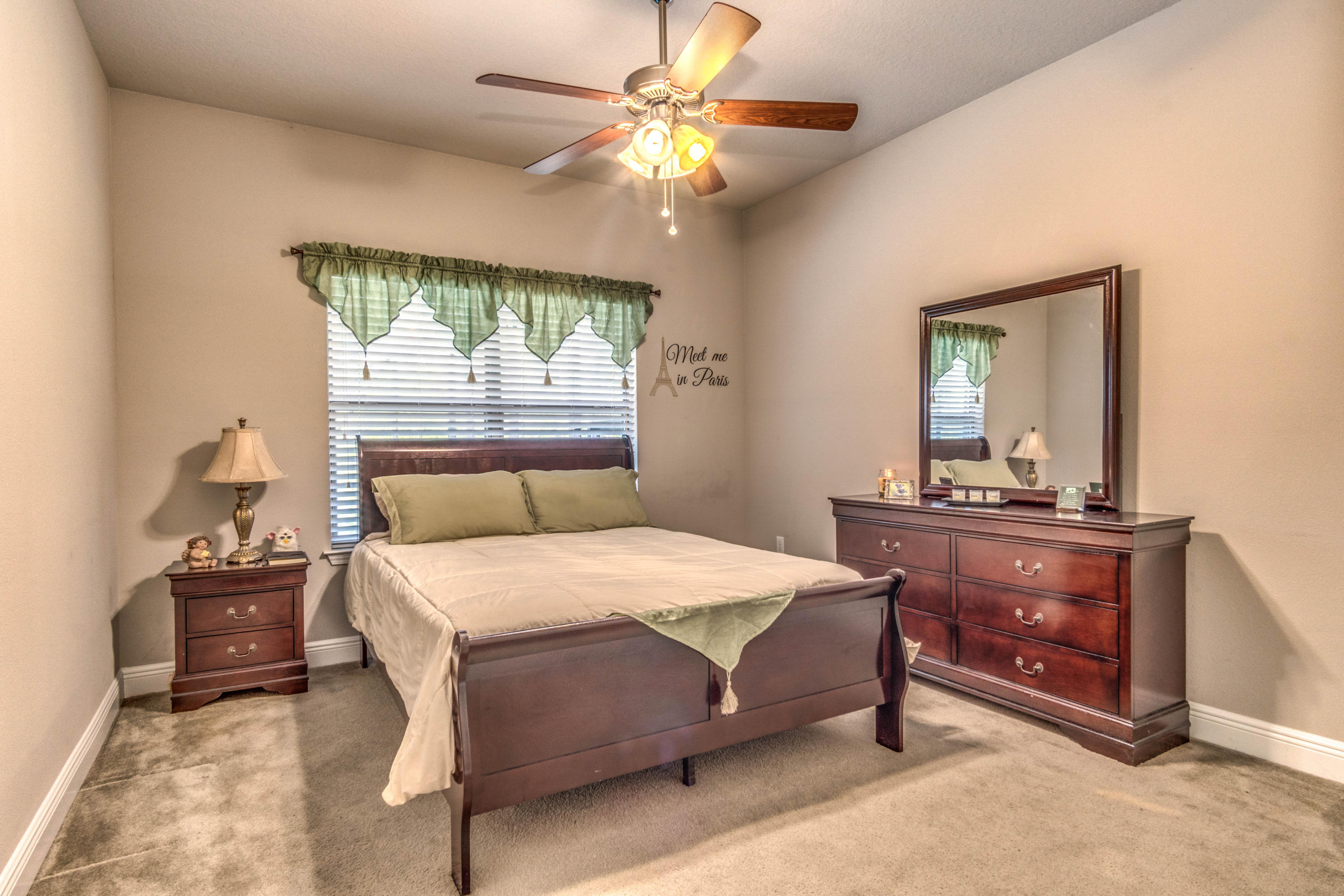 604 Red Fern Road Crestview, FL 32536 - Photo 30 of 36 a bedroom with a bed and a mirror on dresser
