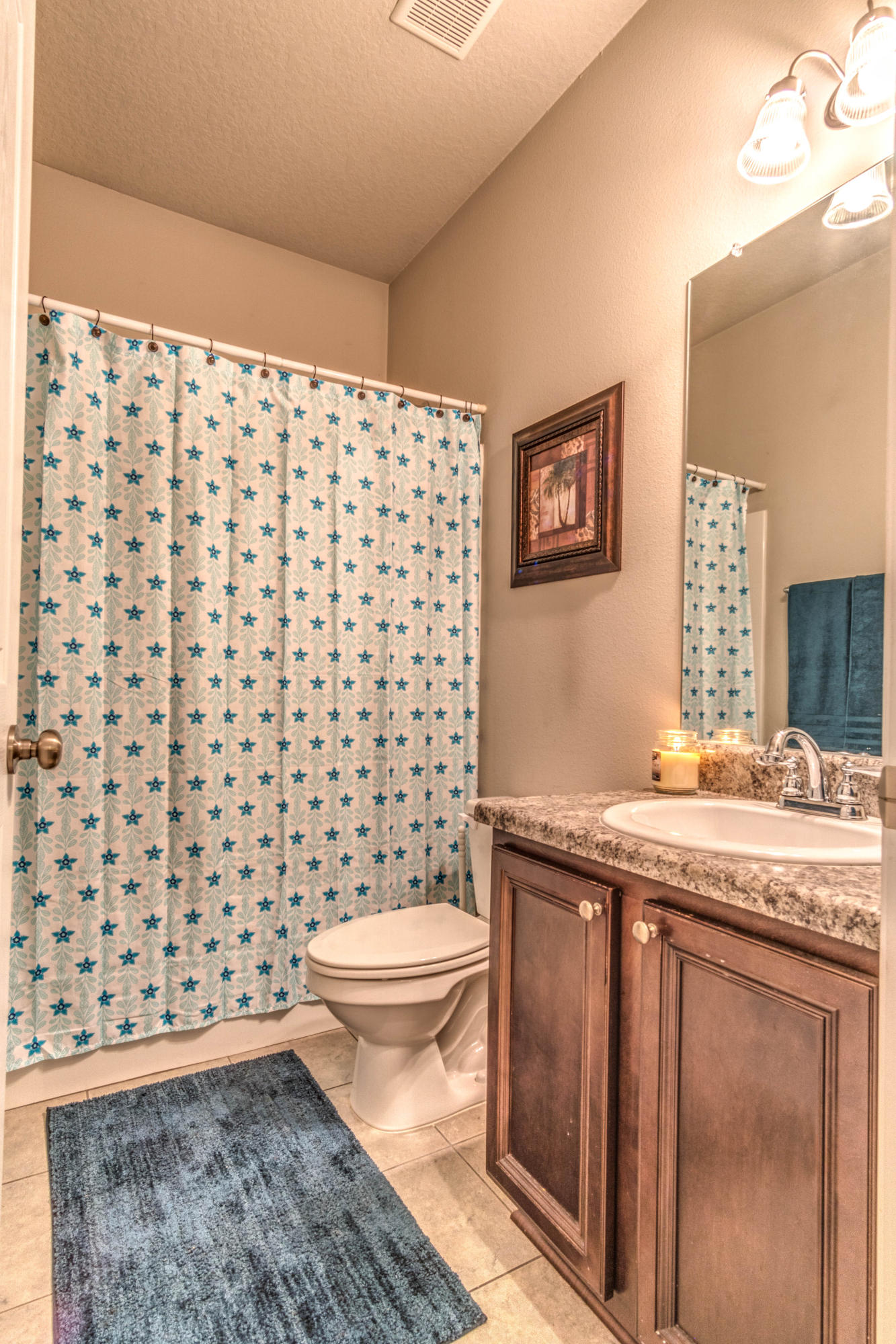 604 Red Fern Road Crestview, FL 32536 - Photo 32 of 36 a bathroom with a granite countertop toilet a sink and a shower