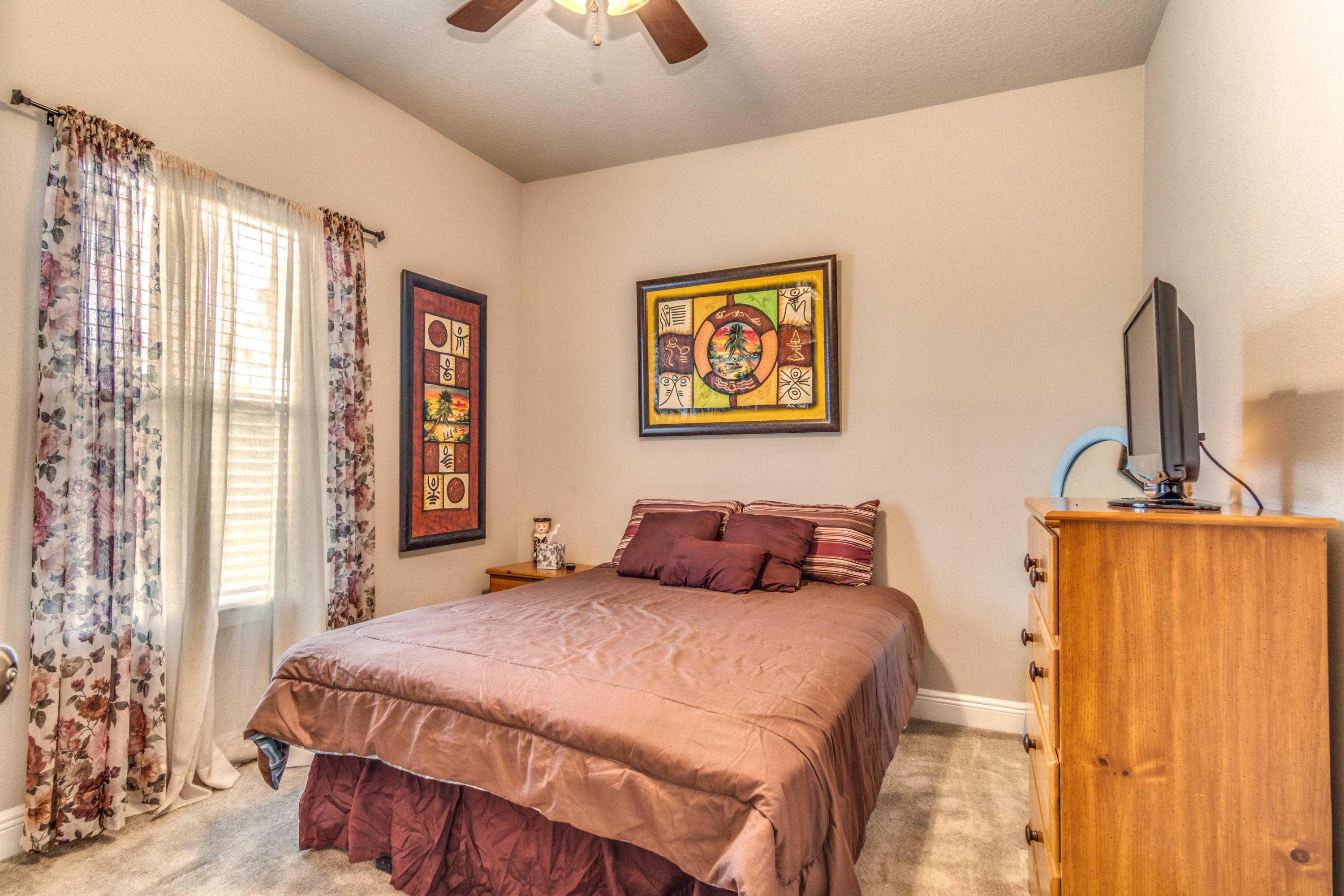 604 Red Fern Road Crestview, FL 32536 - Photo 34 of 36 a bedroom with a bed and a painting on the wall